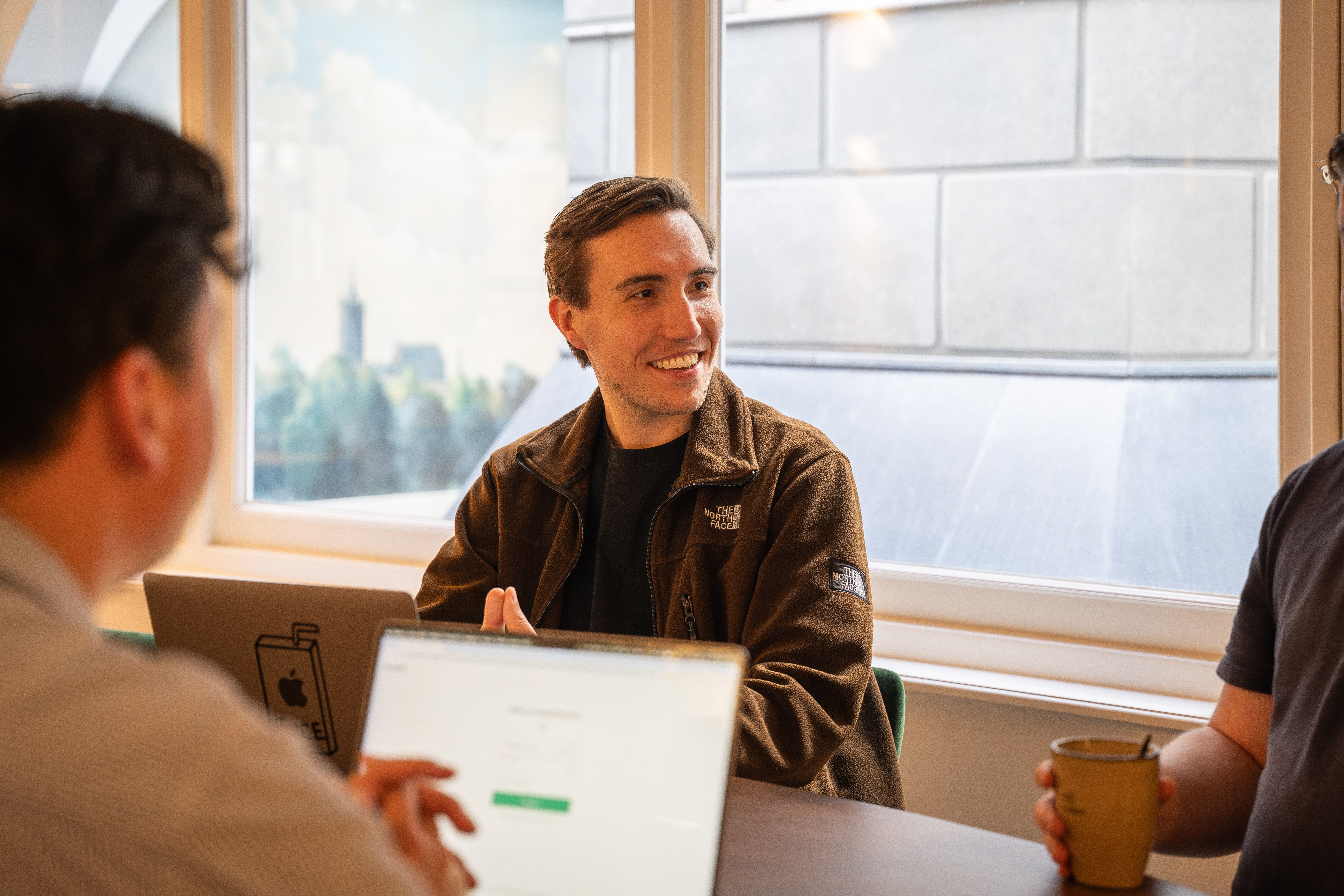 Copilot expert in conversation with colleagues during a working session
